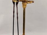 gold plated candle holder with two candles on top of it