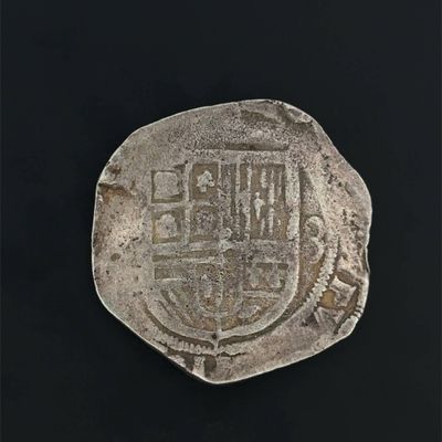 an old silver coin with a coat of arms on it
