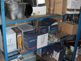 a shelf with many boxes on it in a room