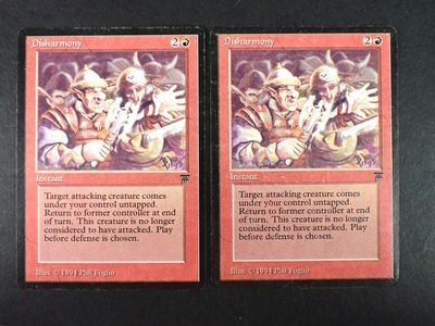 the two cards are on a table with a black background