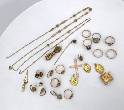 a white plate topped with lots of gold jewelry on top of a table