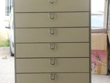 a white cabinet with five drawers on top of it