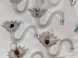 a lot of glass wall sconces hanging on the wall