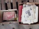 a box full of papers sitting on a wooden bench