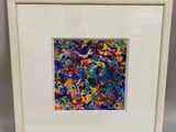 a white framed picture of a colorful abstract painting in a white frame