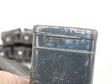 a person holding a small metal box with a broken lid