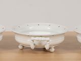 three white bowls sitting on top of a wooden table next to each other
