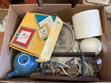 a box with a teapot, a lamp, a tea pot, a lamp, and other items in it
