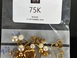 a bag of gold and pearl jewelry on a table