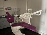 un fauteuil de dentiste avec un siège violet dans une pièce