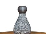 a black and white vase sitting on a wooden table