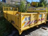 a yellow dump truck that is parked on the side of the road
