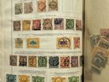 an open book with stamps on it on a table