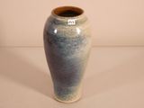 a blue vase that is sitting on a table