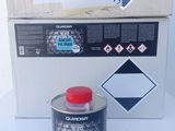 a can of paint next to a box with a sign on it
