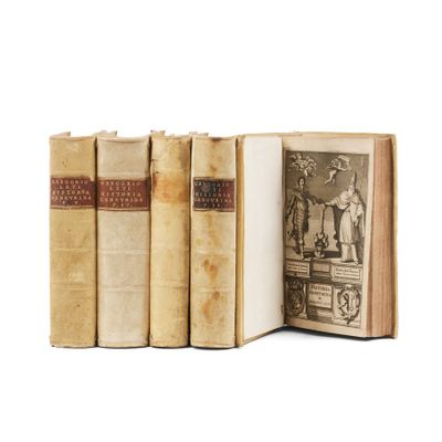 several old books sitting on top of each other on a white surface