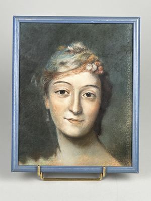 portrait of a woman in a blue dress with a flower in her hair