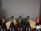 several bottles of wine are lined up in a row on a table