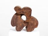 sculptures made of wood sit on a white pedestal against a white background