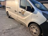 a white van parked in a parking lot next to a building