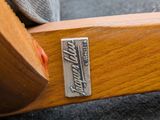 a close up of a wooden bench with a nameplate on it