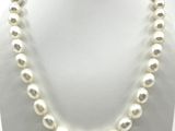 a white pearl necklace on a mannequin display
