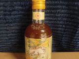a bottle of liquor sitting on top of a cardboard box