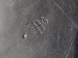 an antique silver plate with numbers on the side of it