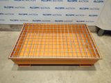 an image of a metal grate on a pallet in front of a blue and white sign