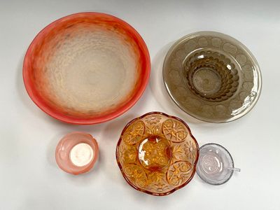 many different bowls and cups on the table