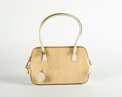 an image of a beige and white handbag on a white background