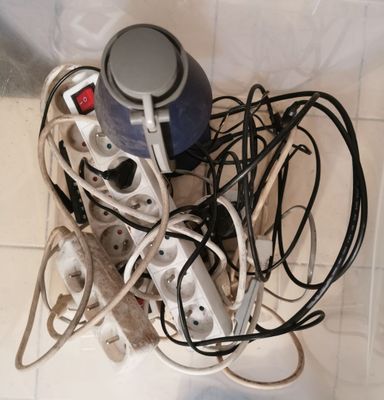 a pile of electrical cords and wires on the floor