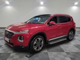 a red 2020 hyundai santa parked in a showroom