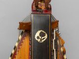 an image of a wooden sculpture of a man with a head on top of a pyramid