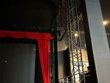 a stage with a red curtain in the middle of it