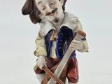 a figurine of a man playing a violin