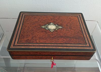 a small wooden box with a decorative decoration on it