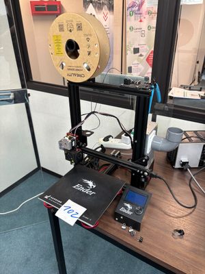 a 3d printer sitting on top of a wooden table