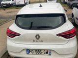 the rear end of a white car parked in a parking lot