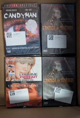 four dvds in a box on a table