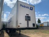 a white box truck that is parked in the grass
