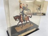 a figurine of a man on a horse in a glass case