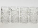 six glasses sitting next to each other on a table