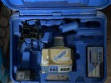 une mallette bleue contenant des outils, posée par terre