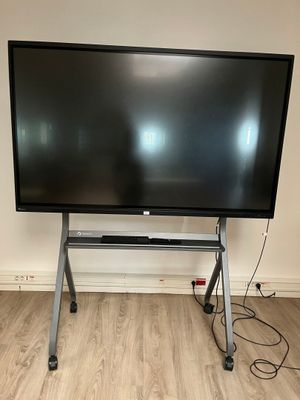 the large flat screen tv is on the stand in the room