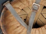 a close up of a baseball helmet with a leather cover