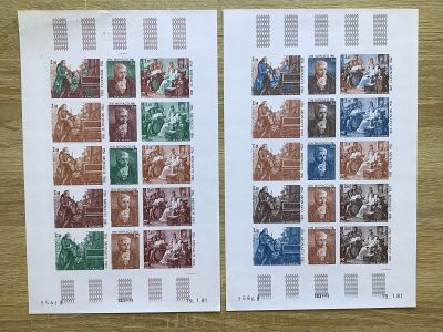 two stamps with different images of people on them on a table