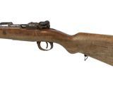 a rifle with a wooden barrel on a white background