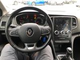 someone is sitting in the driver ' s seat of a car with their feet on the steering wheel