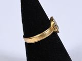 a close up of a gold ring on a black ring holder